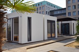 exterior view 2-bed cubes with building in the background